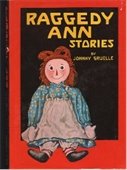 A photo of the book Raggedy Ann Stories featuring a Raggedy Ann Doll and yellow text on a black and red background