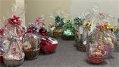 An image with a variety of holiday-themed literary gift baskets wrapped in ribbon and cellophane