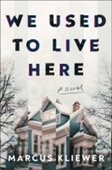 book cover image of We Used to Live Here featuring a distorted image of a large white and blue house