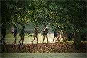 a line of children travel through Sloan Park