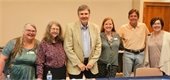 Library staff and the media panelists pose together for a photo in RPL's Hurley Room