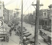 an old black and white photo of Main St. in Salisbury featuring cars and a bustling streetside